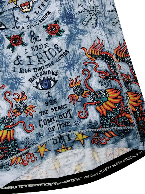 Close-up of a colorful tattoo-style fabric with dragons and text on a blue background.
