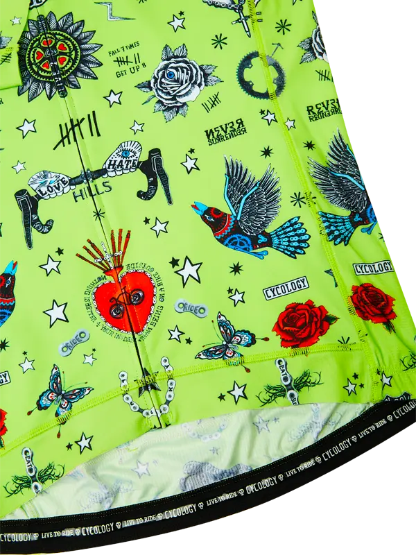 Close-up of a green cycling jersey with colorful designs and text.